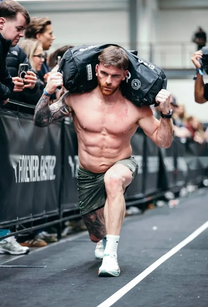 Micheal D carrying a sandbag during competition